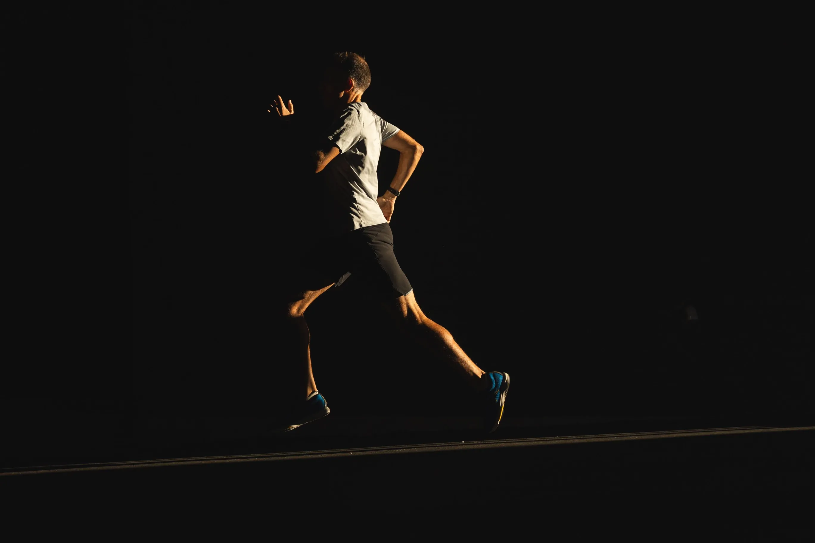 Harvey Lewis running in silhouette at dusk