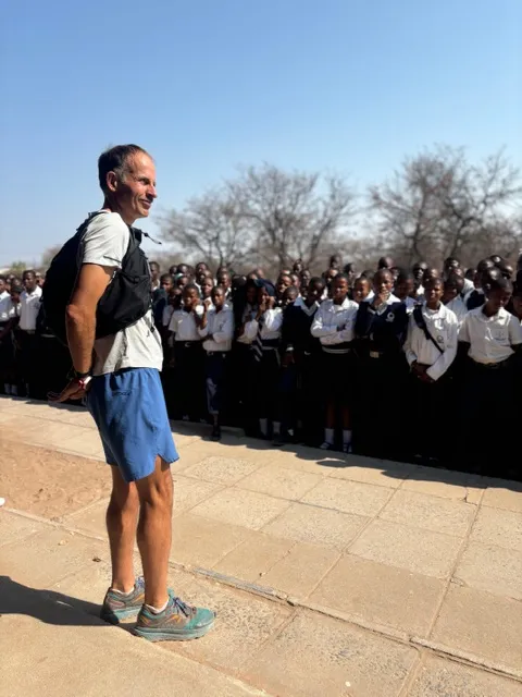 Harvey Lewis speaking to hundreds of schoolchildren outdoors